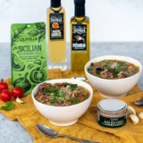 Italian wedding soup with tender meatballs, carrots, spinach, and pasta in a savory broth topped with parmesan