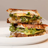 Jalapeño and Monterey Jack Grilled Cheese made with Blake Hill Jalapeño & Lime Spicy Chili Jam, melted cheese, avocado, and microgreens on artisan bread