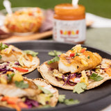 Mango Pineapple Habanero Fish Tacos made with Blake Hill Mango Habanero Chili Jam, grilled white fish, jam-dressed cabbage slaw, and cilantro on warm corn tortillas