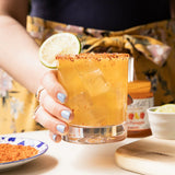 Mango Habanero Margarita made with Blake Hill Mango Habanero Chili Jam, tequila, and Grand Marnier in a Tajín-rimmed rocks glass garnished with lime