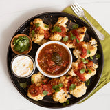 Pan-Roasted Cauliflower wedges with a spicy tomato chutney made with Blake Hill Jalapeño & Lime Spicy Chili Jam, garnished with fresh cilantro and yogurt