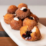 Cinnamon Sugar Yogurt Doughnuts filled with Blake Hill Naked Blueberry Spread and crème fraîche, golden brown and coated in cinnamon sugar