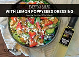 Everyday salad with lemon poppyseed dressing, marinated chicken, strawberries, feta, and pistachios