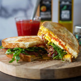 Fried Egg, Prosciutto, and Red Pepper Jam Breakfast Sandwich made with Olivelle Green Chili Infused Olive Oil and Chili Verde Flake Sea Salt