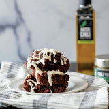 Green Chile Brownies with Cream Cheese Drizzle made with Olivelle Green Chili Infused Olive Oil and Pineapple Habanero White Barrel Aged Balsamic, finished with Chili Verde Flake Sea Salt