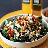 Roasted Chili Chickpea and Kale Salad with sun-dried tomatoes, goat cheese, and pumpkin seeds, made with Olivelle Green Chili Infused Olive Oil and Pineapple Habanero White Barrel Aged Balsamic dressing