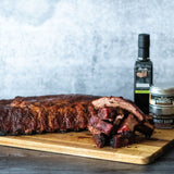 Smokehouse Dry Rubbed Ribs made with Olivelle Sweet Applewood Barbecue Rub, Smokey Bacon Sea Salt, and Bourbon Barrel Aged Balsamic glaze