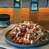 Mediterranean Stuffed Sweet Potatoes topped with crispy chickpeas, feta, and tahini yogurt dressing made with Olivelle Kalamata Greek Extra Virgin Olive Oil