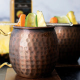 Pineapple Habanero Moscow Mule in a copper mug made with Olivelle Pineapple Habanero White Barrel Aged Balsamic, garnished with pineapple, lime, and habanero