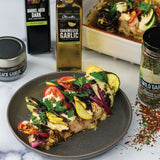 Primavera Hasselback Chicken stuffed with zucchini, tomatoes, and mozzarella, made with Olivelle Caramelized Garlic Infused Olive Oil and Wild Garlic Dried Herb Blend