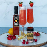 Strawberry lemonade mimosa in a champagne glass garnished with a fresh strawberry