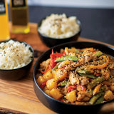 Sweet and Spicy Chicken Stir Fry with pineapple and bell peppers made with Olivelle Green Chili Infused Olive Oil and Pineapple Habanero White Barrel Aged Balsamic, served over jasmine rice