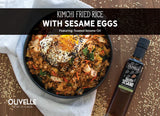 Kimchi Fried Rice topped with a fried egg, green onions, and sesame seeds