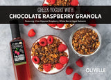 Greek yogurt topped with chocolate raspberry granola, fresh raspberries, and a raspberry balsamic drizzle