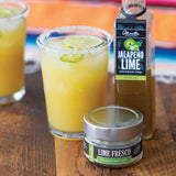 Jalapeño Lime Balsamic Margaritas made with Olivelle Jalapeño Lime White Barrel Aged Balsamic, rimmed with Lime Fresco Sea Salt and garnished with lime slices