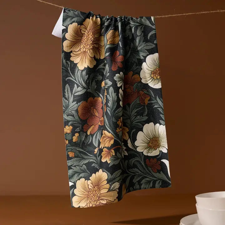 Floral-patterned pants hanging against a brown background