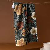 Floral-patterned pants hanging against a brown background