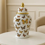 Decorative vase with butterfly patterns on a white surface