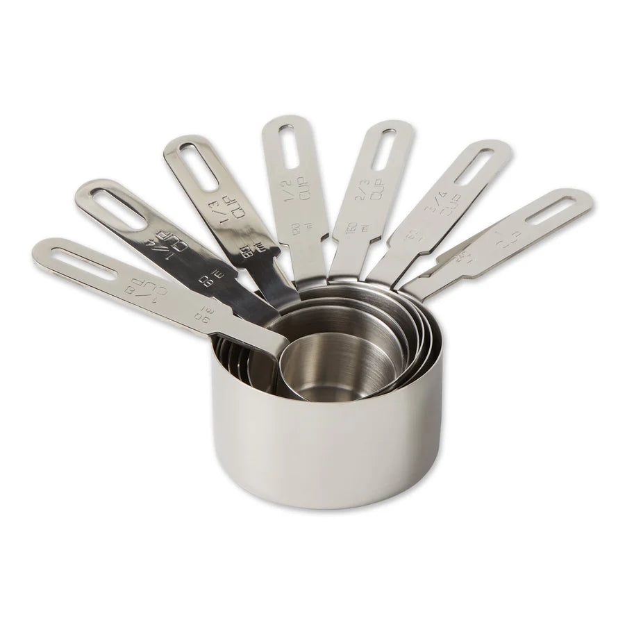Set of stainless steel measuring cups on a white background