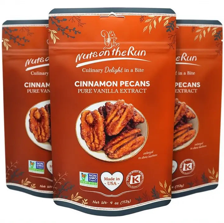 Three stand-up pouches of Nut on the Run Cinnamon Pecans Pure Vanilla Extract arranged in a fan shape against a white background.