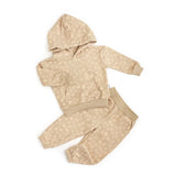 Beige hoodie and pants set with a subtle pattern on a white background