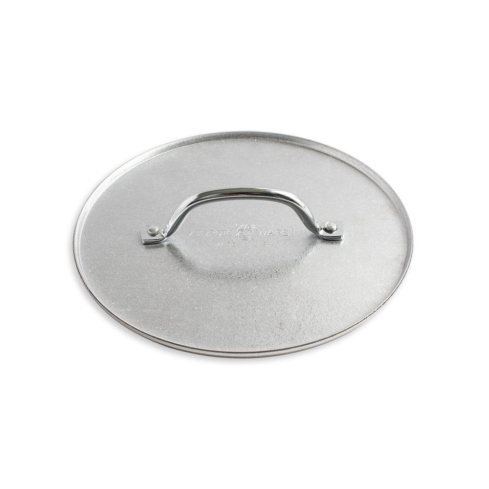 Stainless steel pot lid with handle on a white background