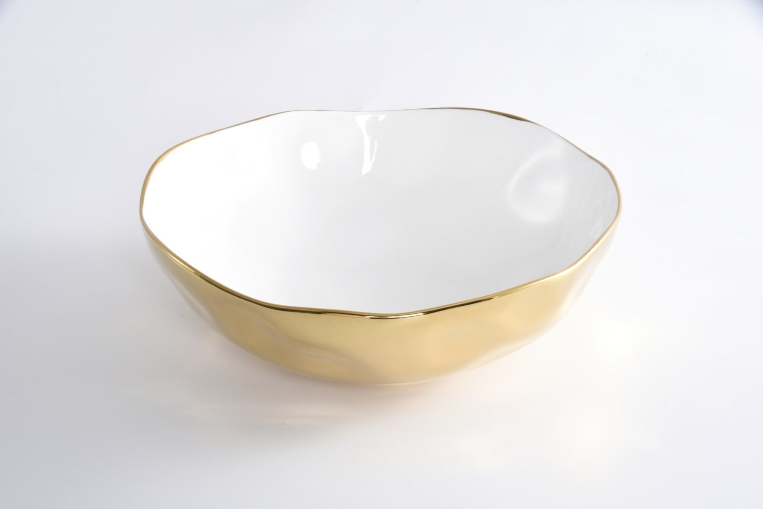 White bowl with gold rim on a white background