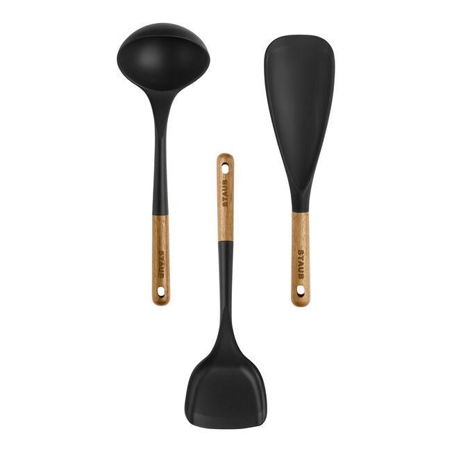 Set of three black kitchen utensils with wooden handles on a white background