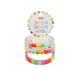 Set of colorful acrylic bracelets in a clear plastic packaging on a white background