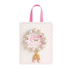 Bracelet with gold charms and pink bow on a white background