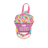 Packaged birthday bracelets with colorful beads and a cupcake-shaped box on a white background
