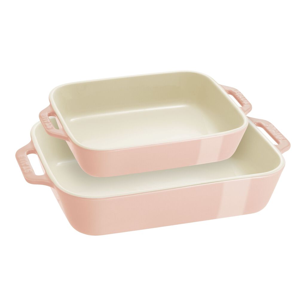 Set of three pink ceramic baking dishes on a white background