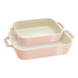 Set of three pink ceramic baking dishes on a white background