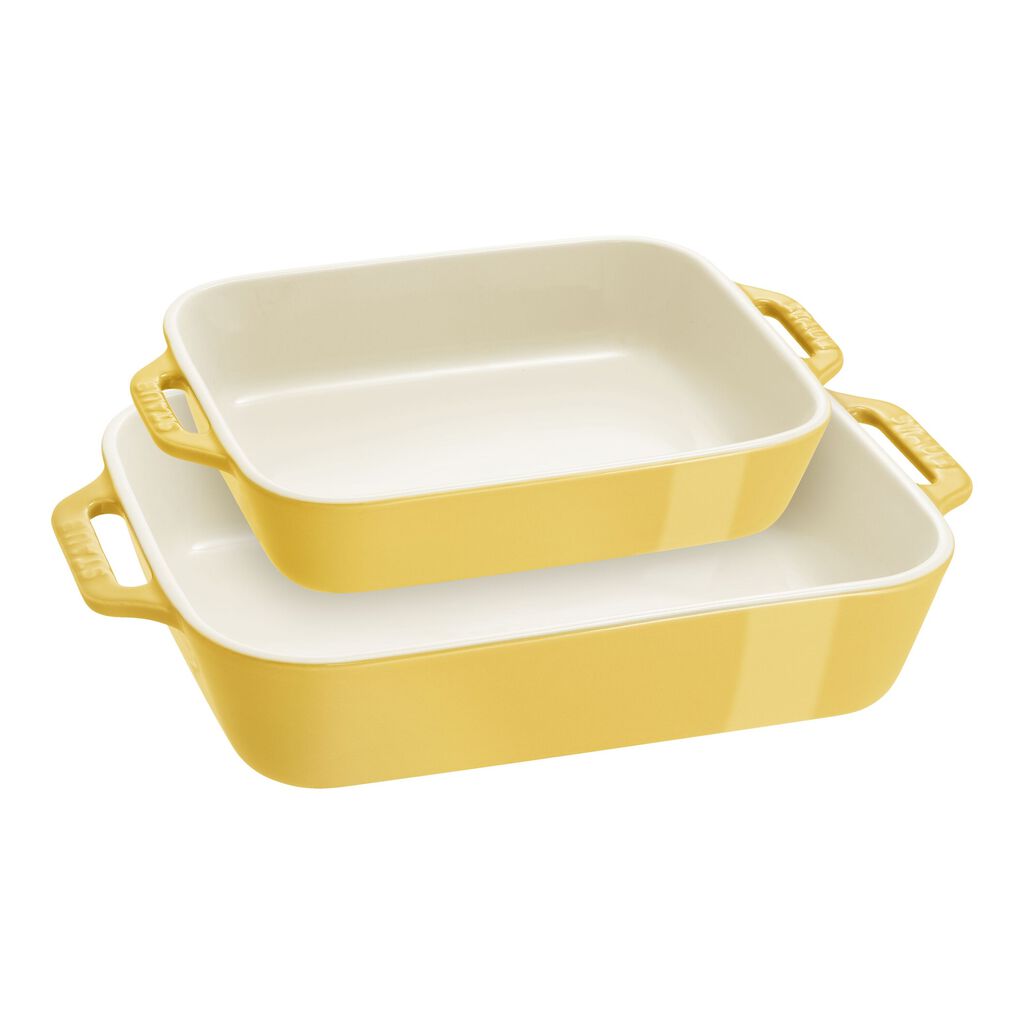 Set of three yellow ceramic baking dishes on a white background