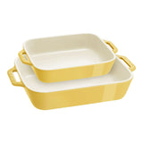 Set of three yellow ceramic baking dishes on a white background