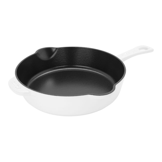 Black cast iron skillet with white handle on a white background