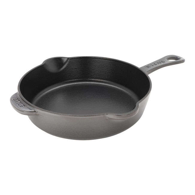 Black cast iron skillet on a white background