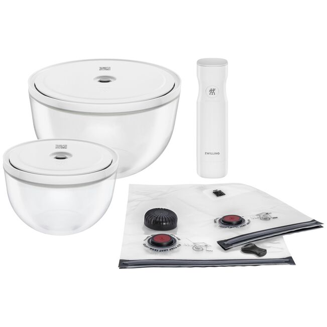 Set of white kitchen items including bowls, a vacuum sealer, and storage bags  on a white background