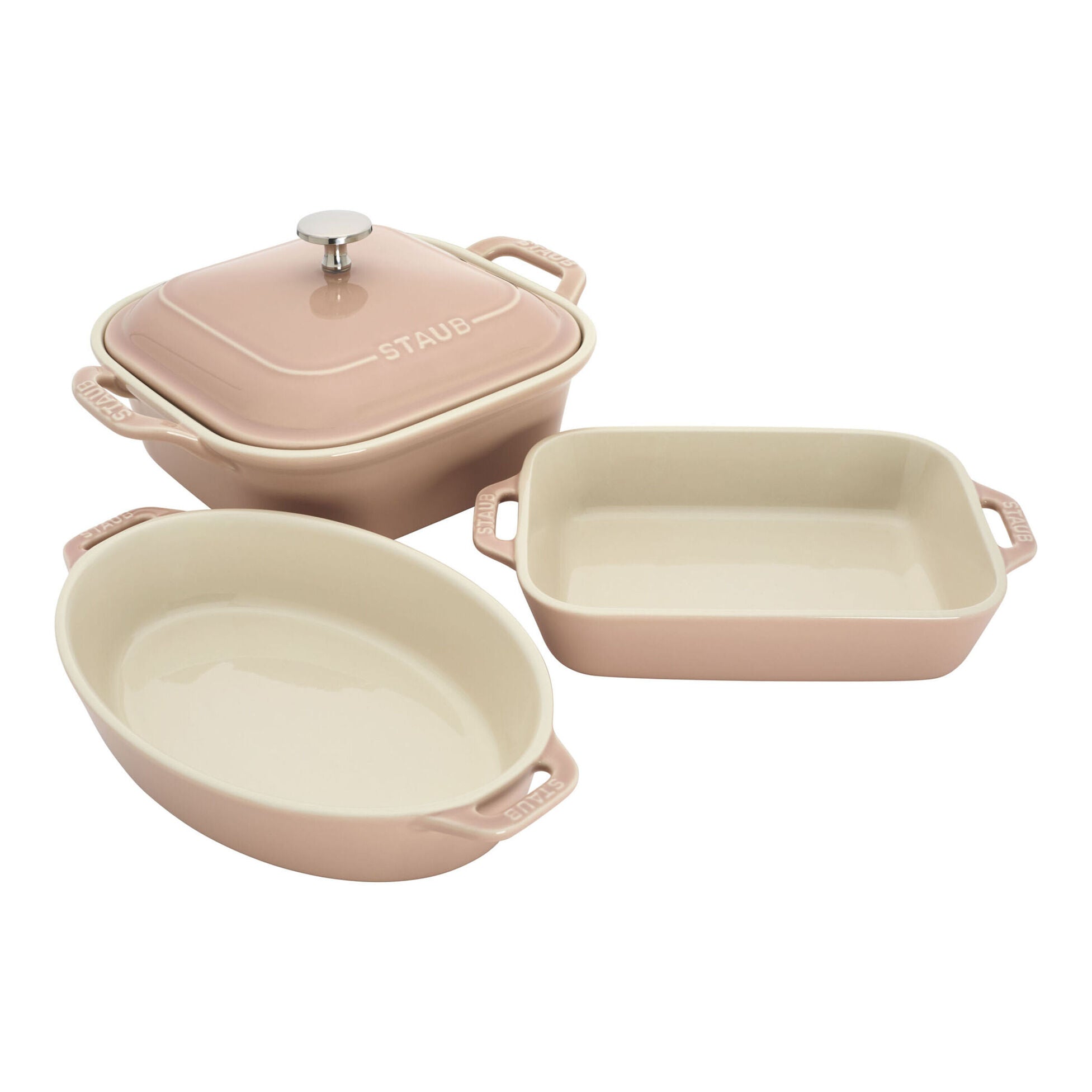 Set of three pink ceramic cookware items on a white background