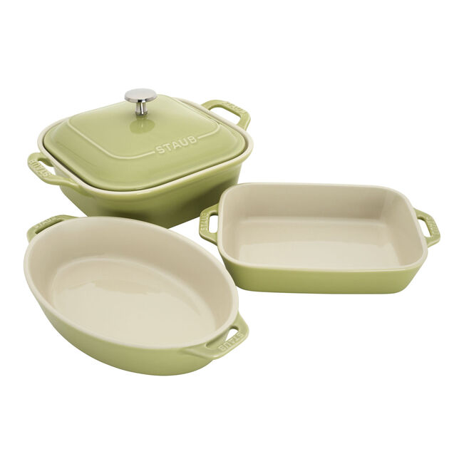 Set of three green ceramic cookware pieces on a white background