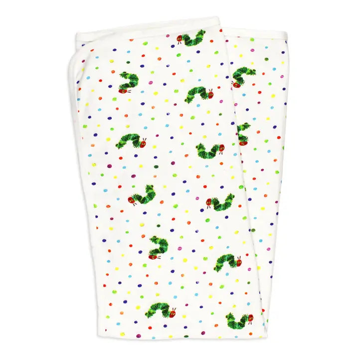 A folded white fabric item, likely a blanket or towel, printed with the classic Green Caterpillar pattern from The Very Hungry Caterpillar book. The design features green caterpillars with red antennae and small multicolored polka dots on a white background.