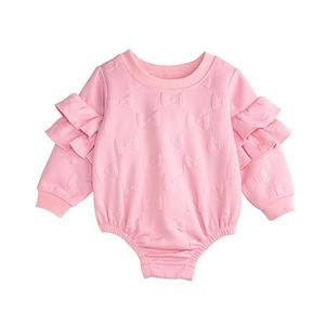 Pink baby romper with ruffled sleeves on a white background