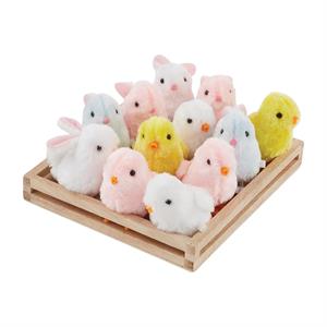 Set of small plush animals including rabbits and chicks on a wooden tray.