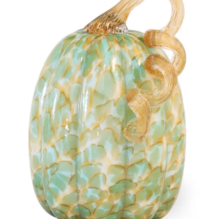Decorative glass pumpkin with gold accents on a white background