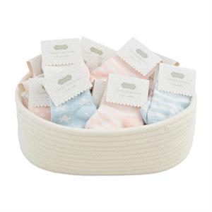 Bowl filled with pastel baby socks on a white background