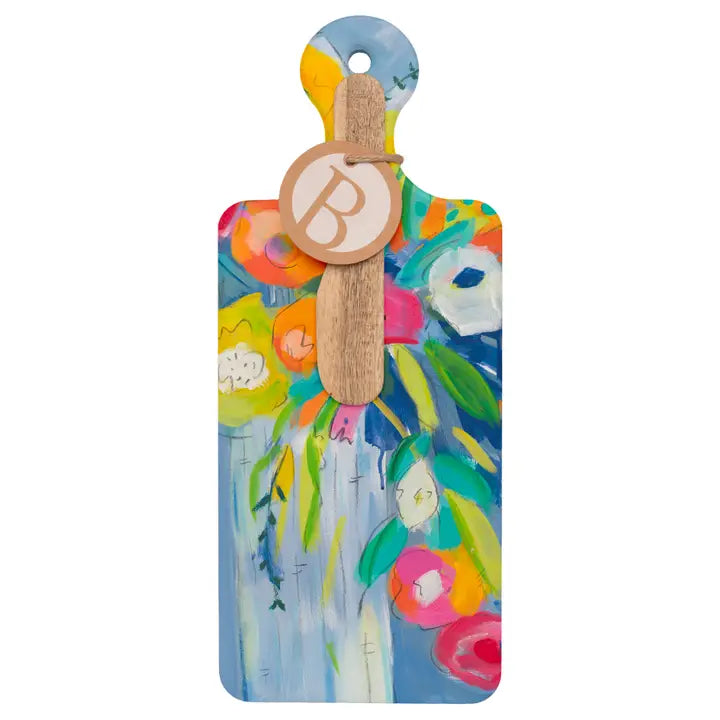 Colorful paddle with floral design and wooden handle on a white background