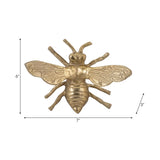 Gold bee-shaped decorative item with measurements on a white background
