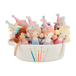 A collection of dolls with birthday hats in a basket.