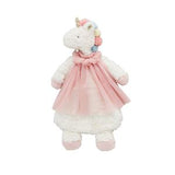 Stuffed unicorn toy in a pink dress on a white background