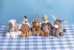 Row of plush toys on a checkered tablecloth with a blue background